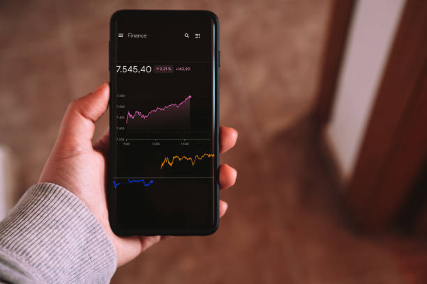istock Woman checking financial data of forex trading chart on smartphone. 1499162529