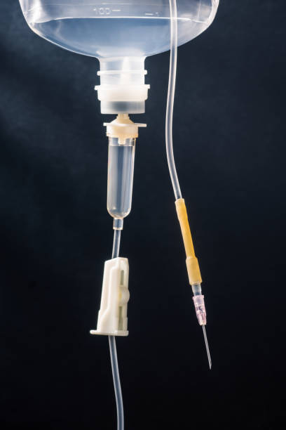 istock hypodermic syringe and disposable infusion set on art dark background 1499165719