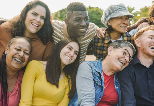 istock Happy multi generational people having fun hugging each other at city park - Multiracial community enjoy day outdoor 1499166494