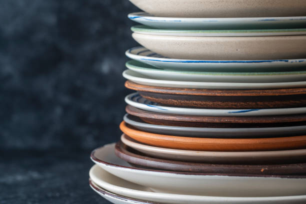 istock Many empty plate on black background, close up 1499169235