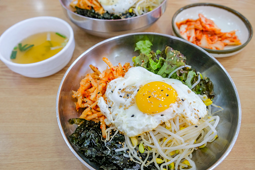 Bibimbap, a traditional Korean food, is a bowl of rice mixed with assorted vegetables and egg. South Korea