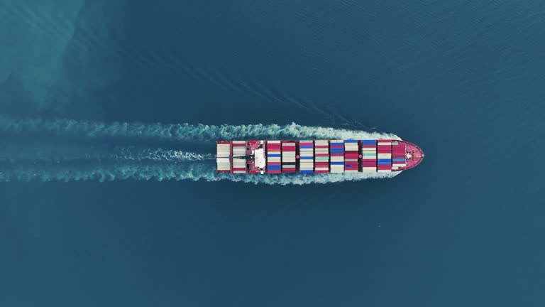 Cargo container Ship, cargo maritime ship with contrail in the ocean ship carrying container and running for export concept technology freight shipping sea freight by Express Ship. top view