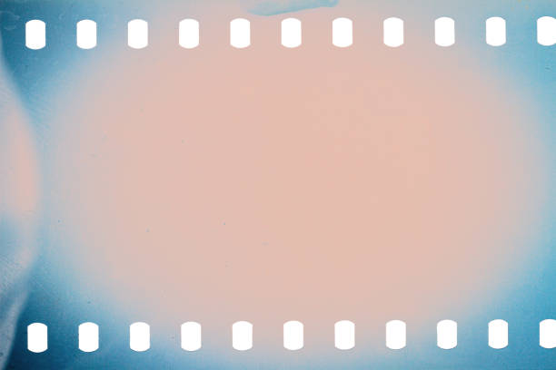 Dusty and grungy 35mm film texture or surface. Perforated scratched camera film isolated on white background.
