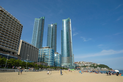 Busan, South Korea - May 27, 2023: People walking along the Haeundae Beach in Busan, South Korea.