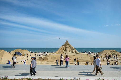 Busan, South Korea - May 27, 2023: People walking along the Haeundae Beach in Busan, South Korea.