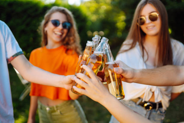 istock Group of friends having fun while drinking beer in picnic 1499172325