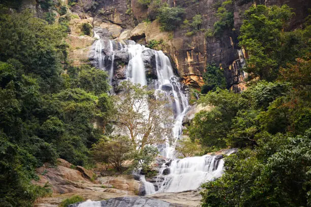 Cascade of high waterfall in pure nature. Ravana Falls near city Ella in Sri Lanka.