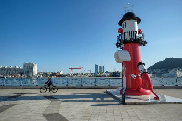 Busan, South Korea - June 1, 2023: A man riding a bicycle through Yongmi-gil Seaview Park in Busan, South Korea.
