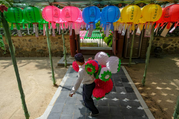 Gyeongju, South Korea - June 2, 2023: A man carrying lanterns at the Bulguksa temple. It is a Buddhist temple in Gyeongju, South Korea.