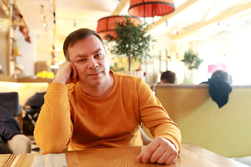Portrait of man waiting for waiter in cafe