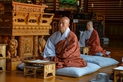 Gimjesi, South Korea - June 6, 2023: Monks praying at Geumsansa Temple, it is a Buddhist temple located in Moaksan Provincial Park in Gimjesi, South Korea.