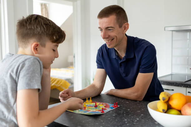 istock Father and son playing board games 1499176346