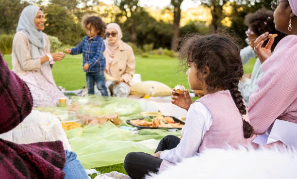 istock Small girl eating during picnic party at a park 1499176708