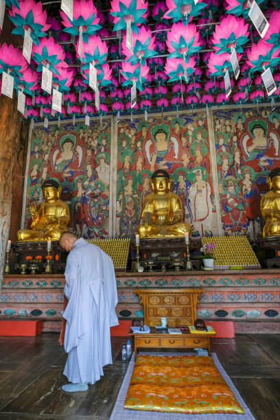 Gongju, South Korea - June 9, 2023: Monk praying at Magoksa Temple, it is a Buddhist temple located in Gongju, South Korea.