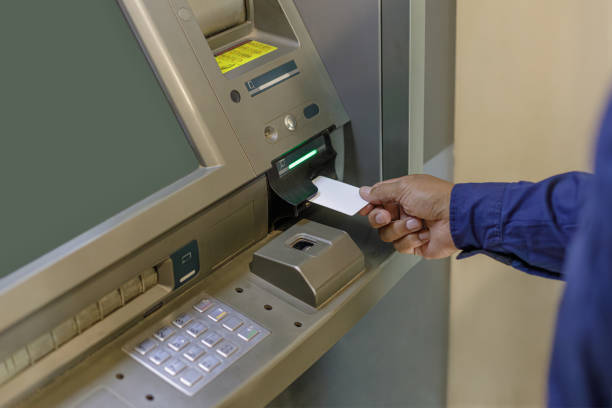 istock A man's hand inserting a blank card into an ATM. 1499176972