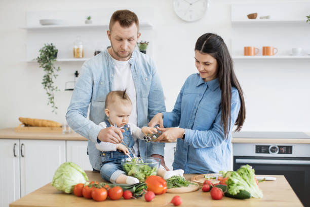 istock Mom with child pouring olive oil into bowl with dad's help 1499178986