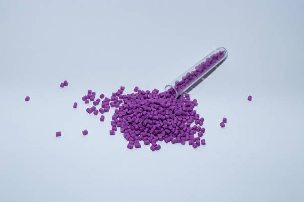 istock Violet of plastic polymer granules on white background. 1499181987