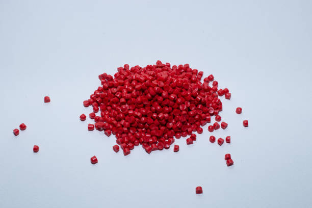 istock Red of plastic polymer granules on white background. 1499182370