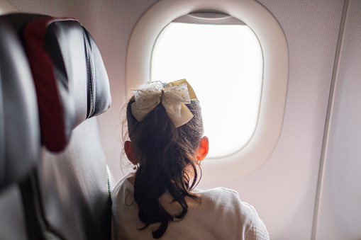 Latino family with children of average age from 9 to 4 years old are on the plane in which they are going to travel to their destination, which is the beautiful island of San Andres.