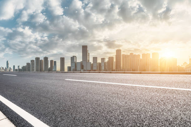 istock Empty asphalt road and city buildings skyline 1499184205