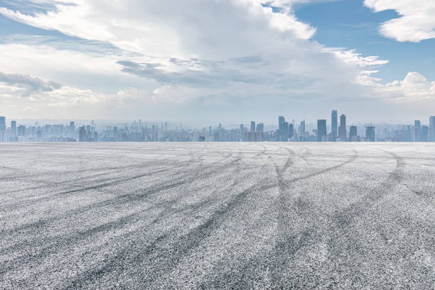 istock Empty asphalt road and city buildings skyline 1499184240