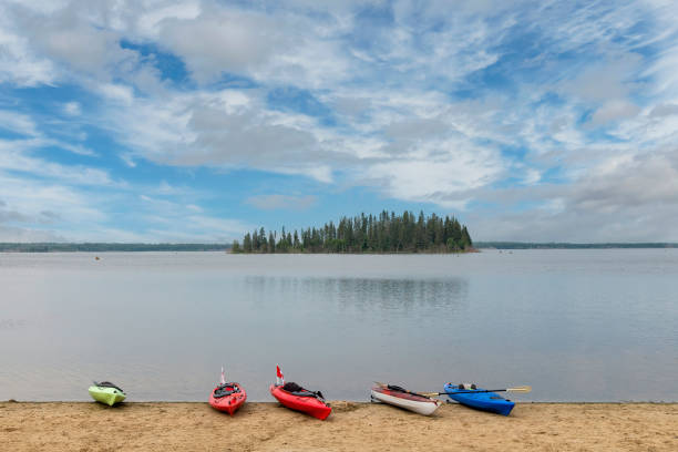 Panoramic view with some canoes on shore over Astotin Lake