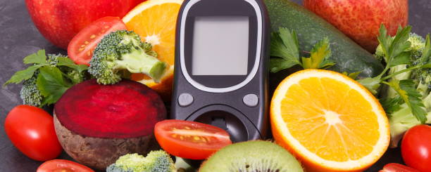 istock Glucometer for checking sugar level with fruits and vegetables containing vitamins, healthy eating for diabetic 1499187471