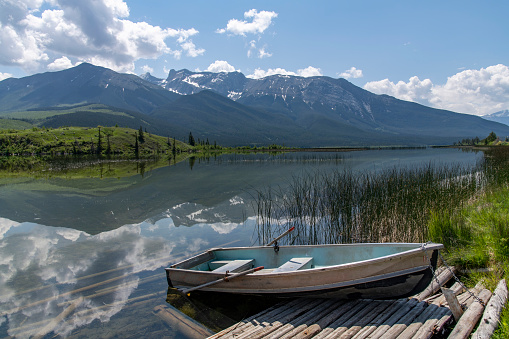 Lone boat sitting on the shore . lake ready for recreation near