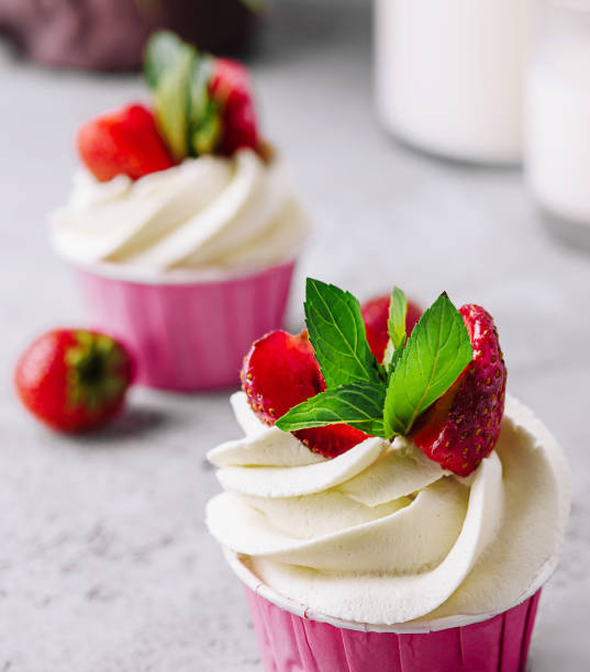 istock Vanilla cupcake with white cream and strawberries 1499191388