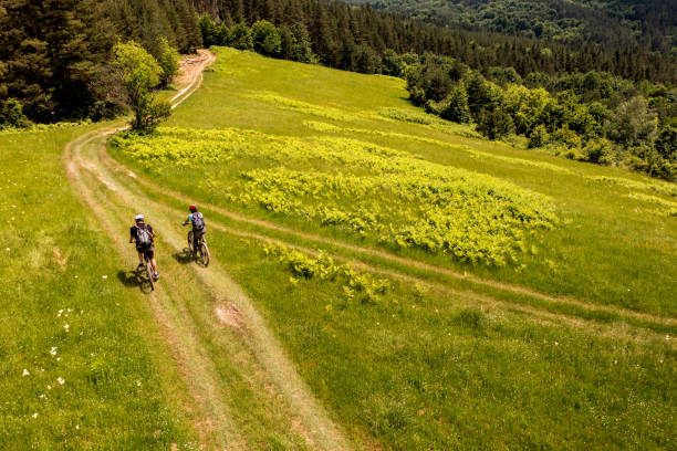 istock Young couple riding bikes bikes through beautiful springtime mountain terrain 1499191512