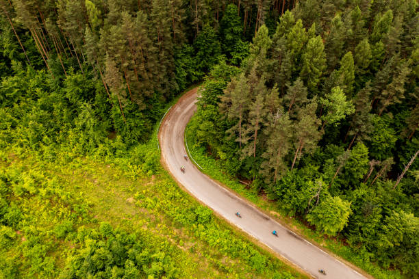istock Road cyclists racing through beautiful mountain area 1499191517