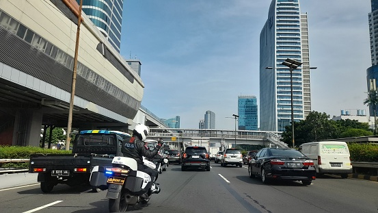 A police officer and his big motor bike drove in the Inner Ring Road toll of Jakarta (Tol Dalam Kota) during the morning traffic jam.