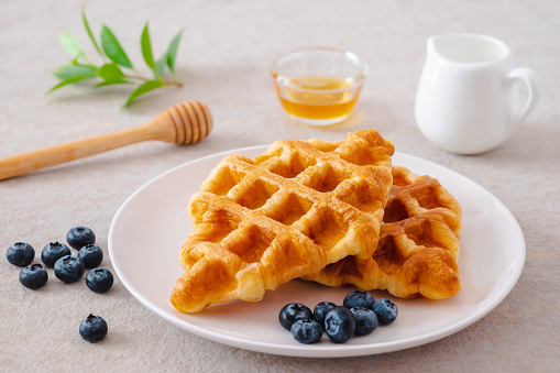 Croffle or croissant waffle with blueberries on plate