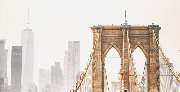 Close-Up Brooklyn Bridge's Upper Parts and Skyscraper's Silhouettes of Manhattan, New York City.