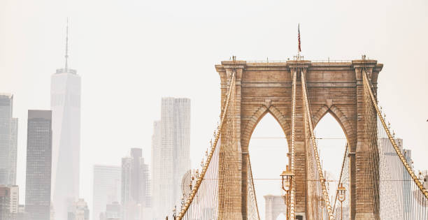 Close-Up Brooklyn Bridge's Upper Parts and Skyscraper's Silhouettes of Manhattan, New York City. stock photo