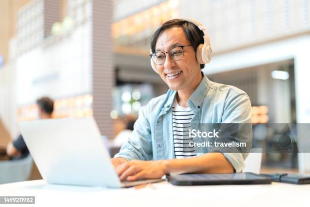 Smart Confidence Asian Startup Entrepreneur Business Owner Businessman Smile Using Laptop Working Online While Listening Music Wireless Headphone Working Relax Leisure In Cafe Stock Photo - Download Image Now