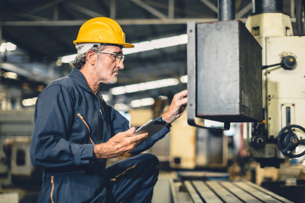 istock Senior elderly engineer worker high skill operate automate CNC lathe machine in automation factory. 1499212770