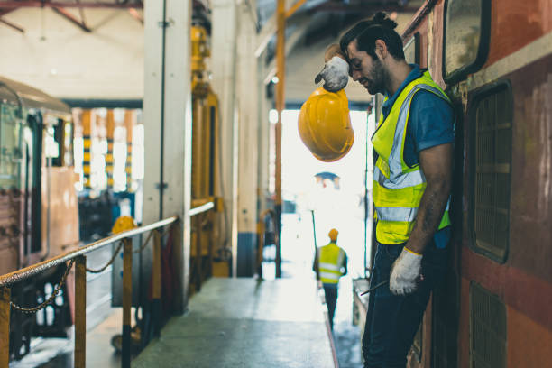 tired exhausted worker hard work, locomotive engineer mechanic staff feel fatigue work in train repair shop service station dirty hot workplace machine factory. - harsh conditions imagens e fotografias de stock