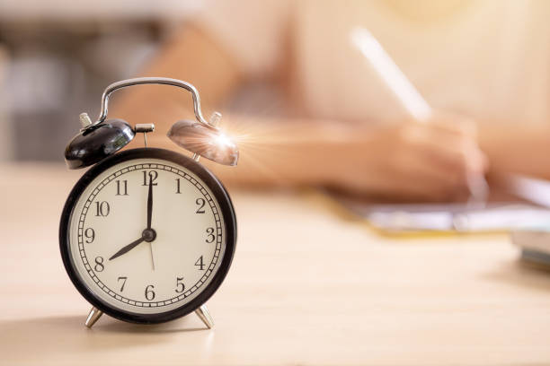 Education alarm times clock School student learning study writing at the morning blur background.