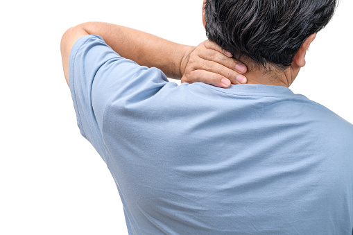 Middle aged man feel neck pain due to working in front of a computer for a long time isolated on white background. health care concepty