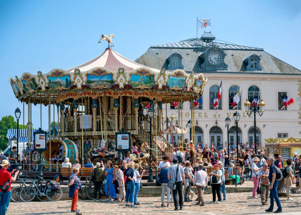 merry-go-round before townhall in Honfleur merry-go-round before the townhall of the village Honfleur in the Normandy at Marine day (Fête des Marins) on Pentecost, France whitsun stock pictures, royalty-free photos & images