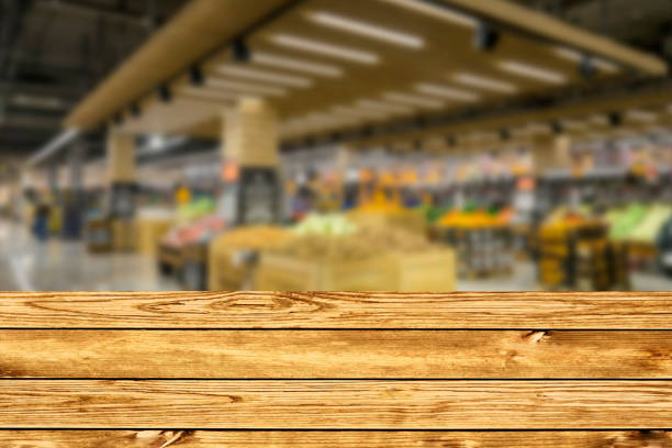 istock Empty wood table top on blurred market fruit. can montage or display your products 1499219920