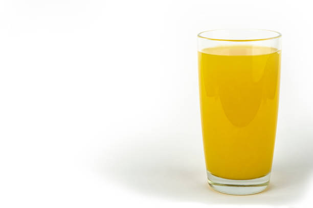 istock single glass of orange juice isolated on white background 1499220559