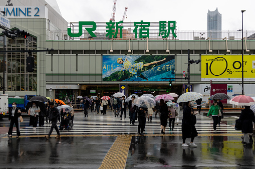 Tokyo, Japan - May 23 , 2023 : People walk in the rainy day in Tokyo's Shinjuku area in Japan.