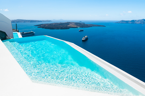 Santorini island, Greece. Luxury swimming pool with sea view. Travel and summer vacation concept