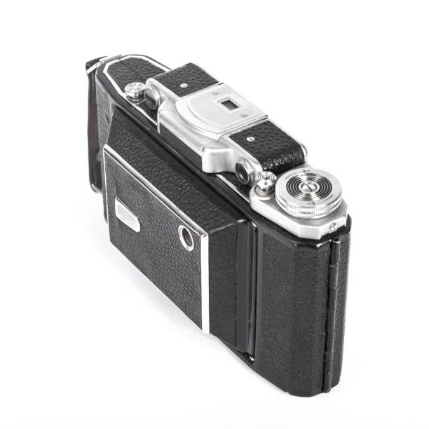 istock Old, antique pocket camera. The black camera is covered with a black leather handle. Front view on a white background 1499222219