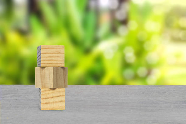 istock Stacked wooden blocks in layers on table. 1499223125
