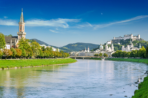 Salzburg, city in Austria, with the Old Town across the Salzach river, Salzburg Cathedral, and Hohensalzburg Fortress in the distance. On the left the Christian Church or Lutheran Church of Austria.