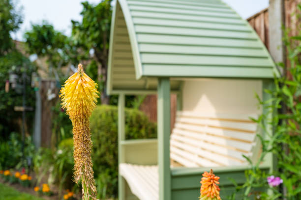 Shallow focus of a Red Hot Poker plant seen in an ornate garden. stock photo