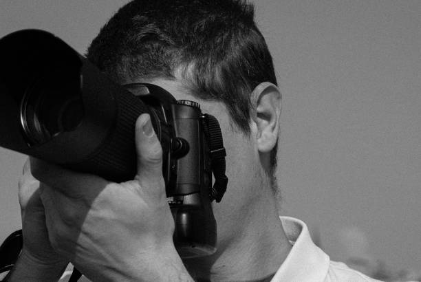istock a portrait of a young man using a camera 1499230668